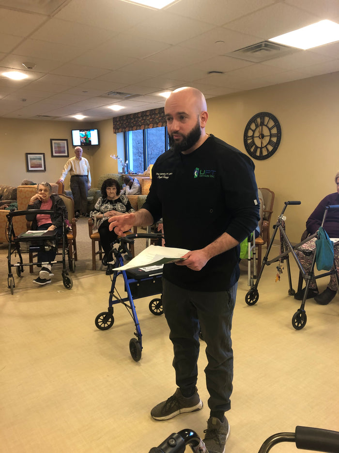Dr. Oleg Uzhansky giving an educational talk to older adults at a senior center