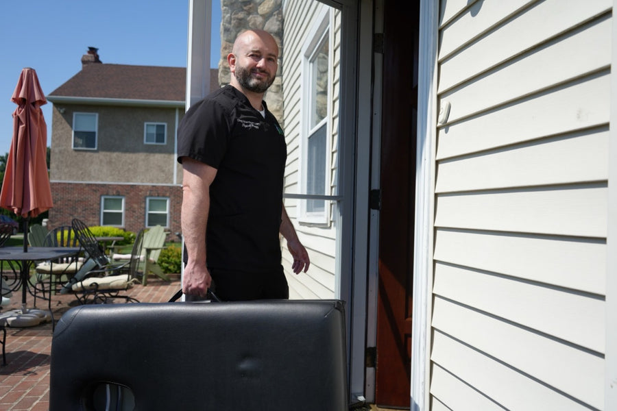 Dr. Oleg Uzhansky arriving at a patient's home with a portable treatment table